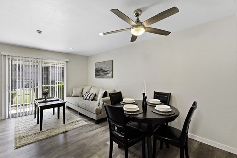 a living room with a dining room table and a couch